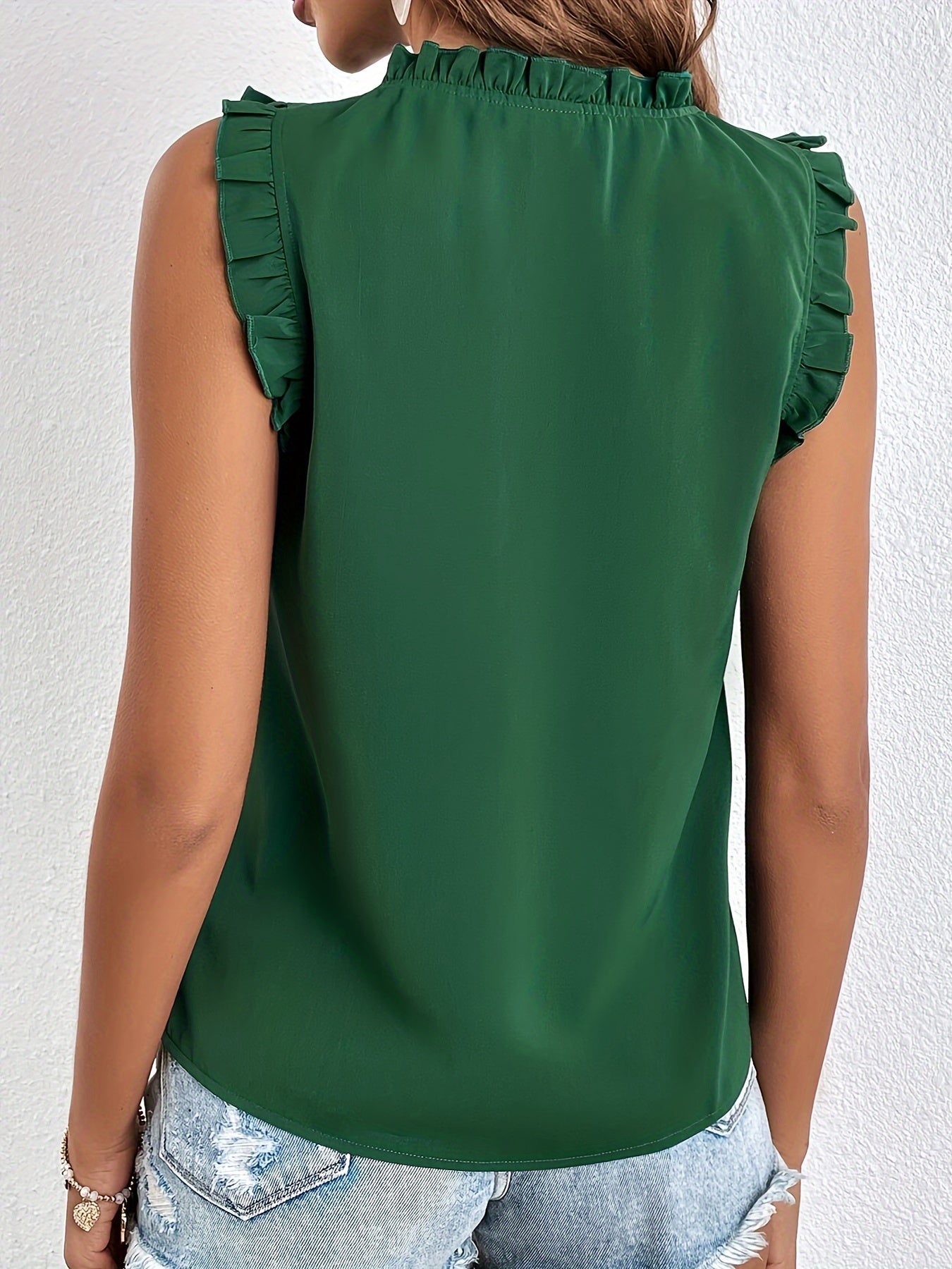Women's sleeveless blouse with a ruffle at the neckline and tie
