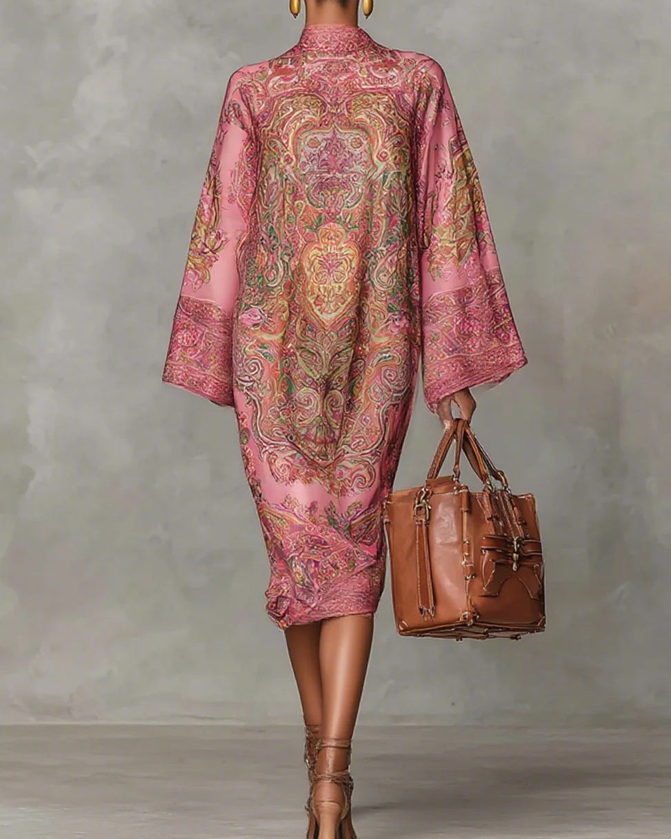 Pink midi dress with paisley pattern, featuring wide sleeves and long sleeves.